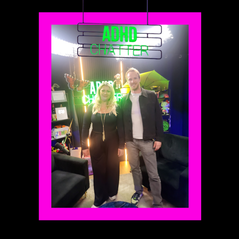 ADHD Chatter podcast guest Serena Palmer Two people stand together in a brightly coloured studio with neon signs.